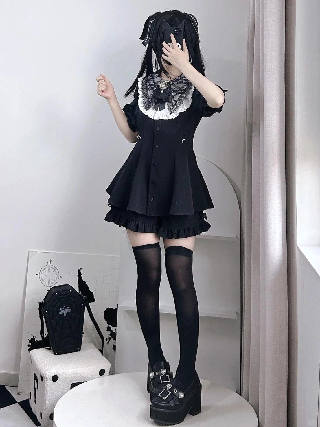Black Jirai Kei dress set with white lace puritan collar and ruffled hem, worn with thigh-high socks and platform boots in full-body front standing studio view