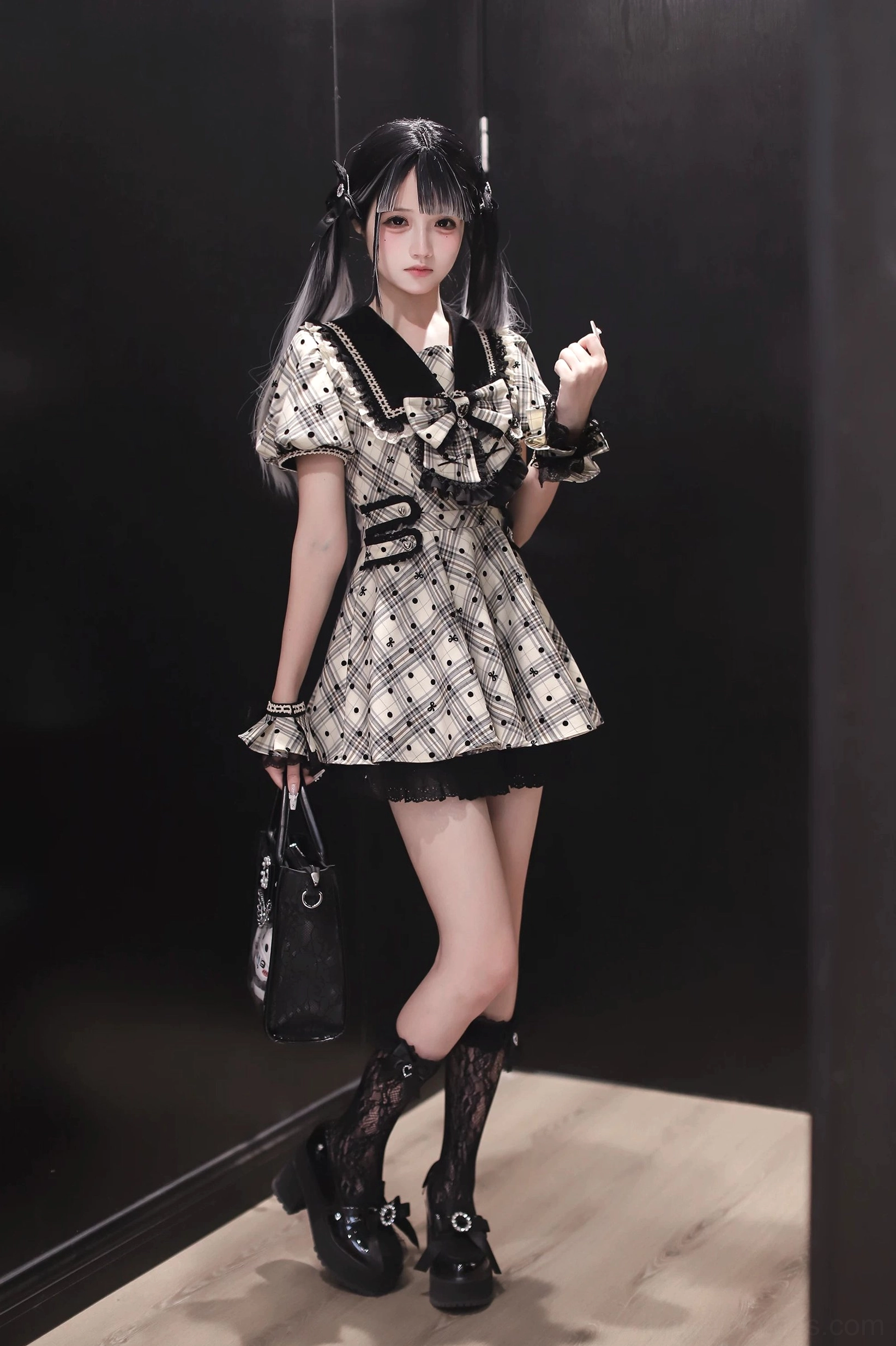 Side detail view of Jirai Kei dress showing zipper closure and black lace trim on plaid polka dot fabric