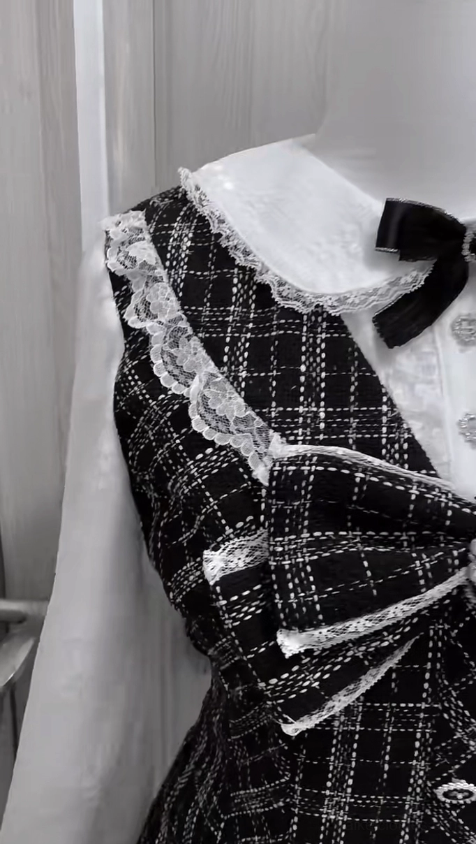 Close-up detail of Jirai Kei dress upper body showing velvet neck bow, plaid decorative bow accents, button row closure, and lace collar framing for styling inspiration