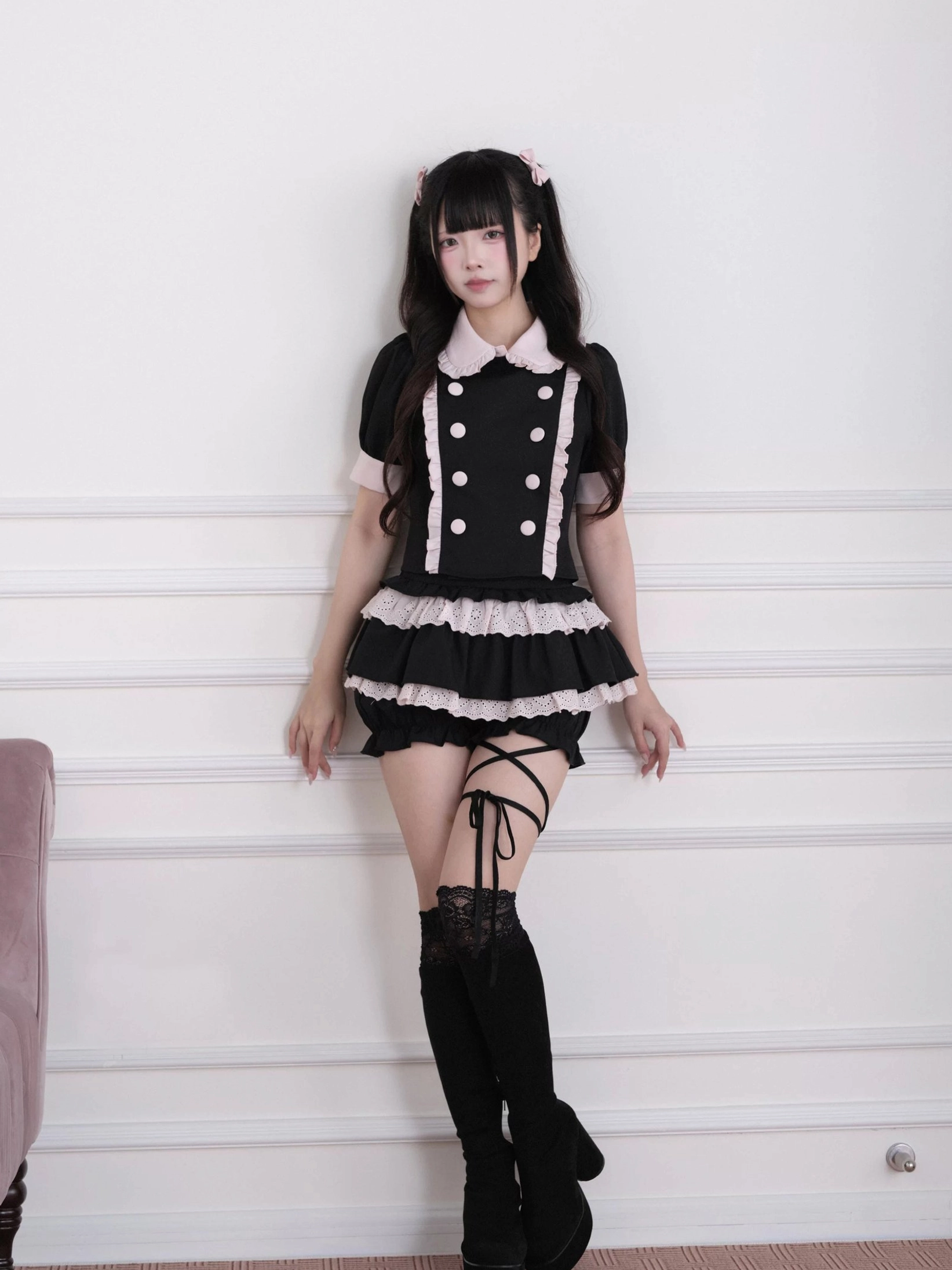 Full-length vertical fashion photography of jirai kei double-breasted blouse and ruffled skort ensemble worn styling demonstration