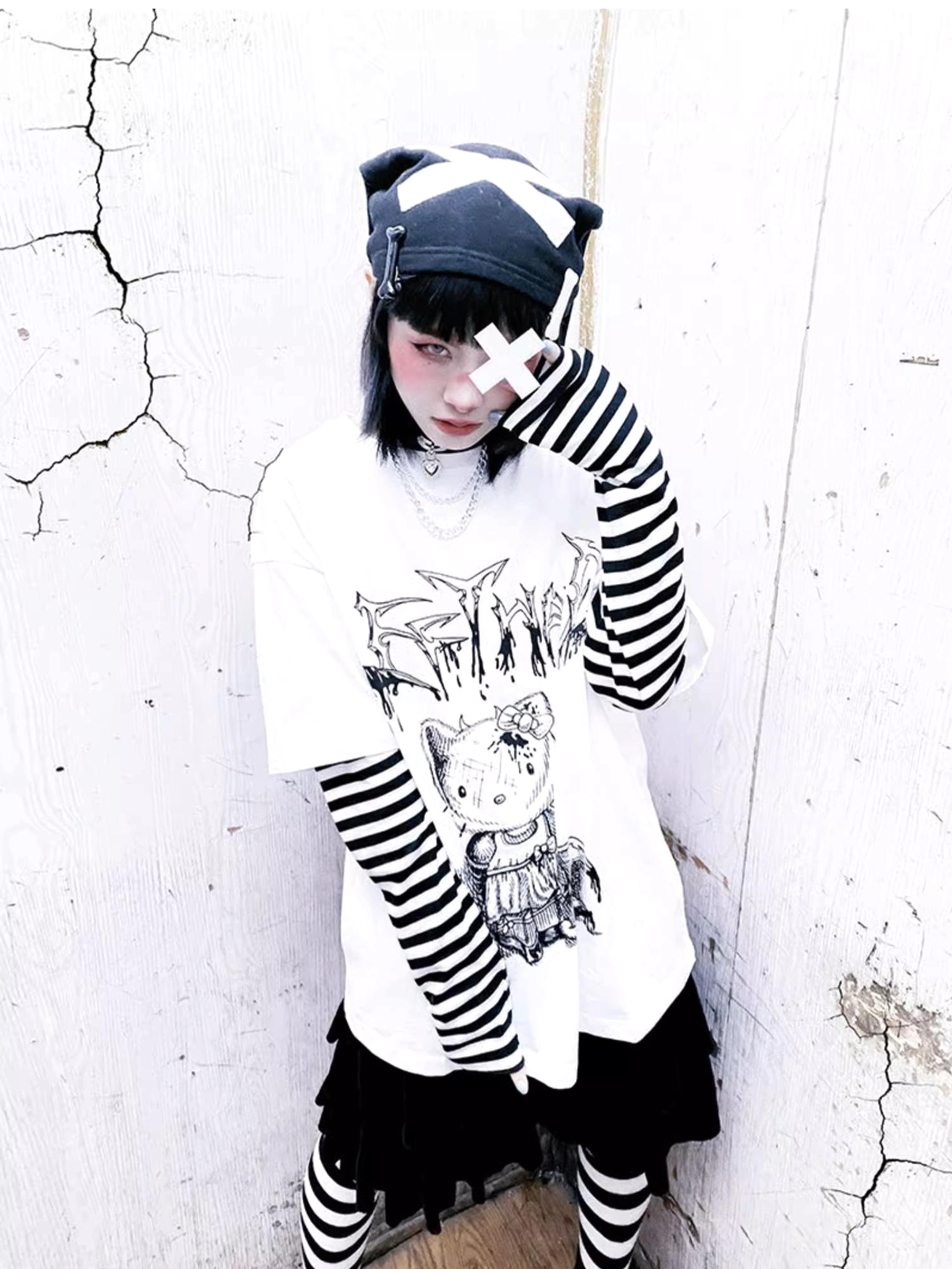 Side view of jirai kei false two-piece long sleeve tee highlighting striped sleeve and false layering construction detail