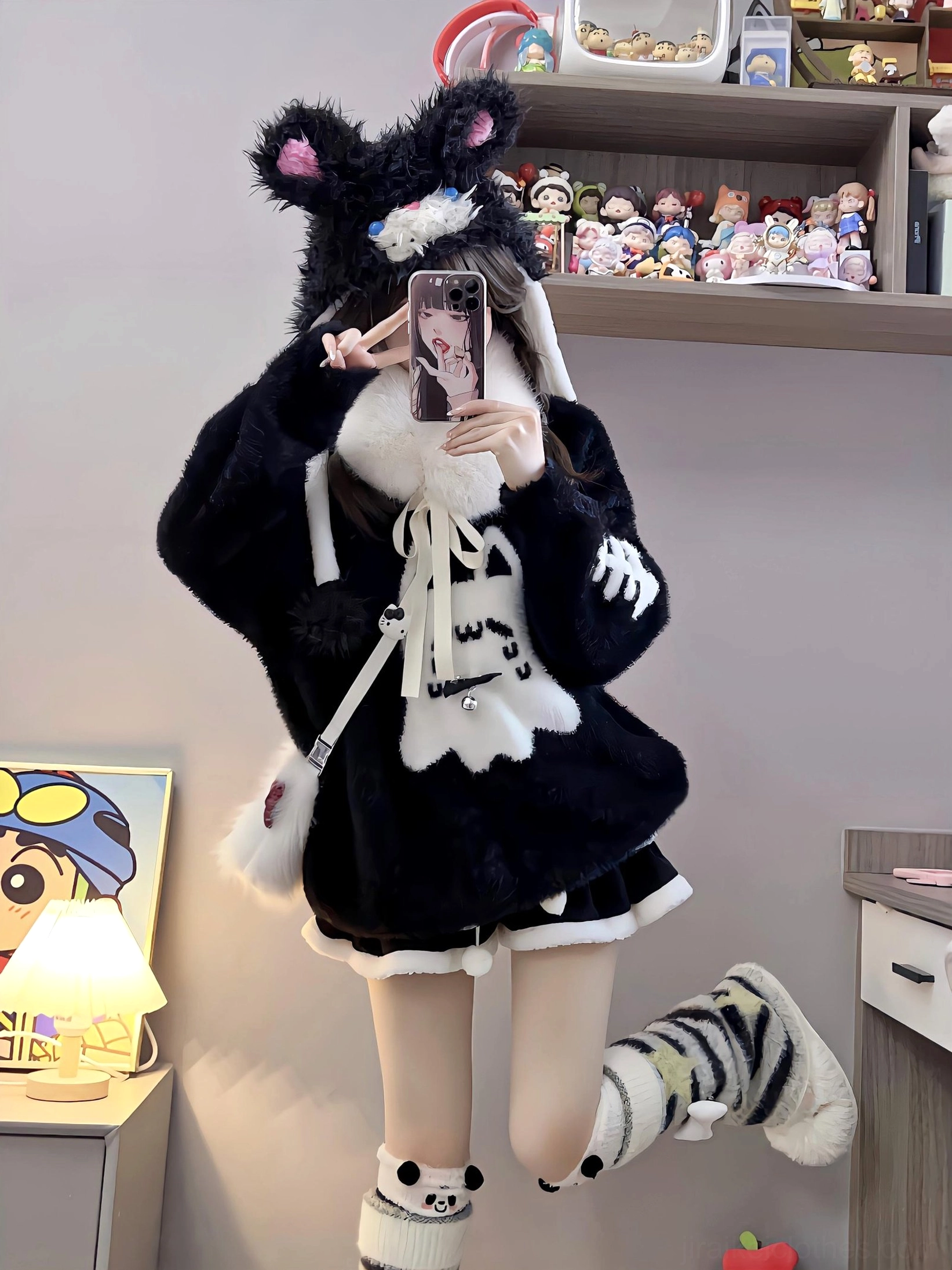 Playful jumping full-body mirror selfie of Jirai Kei ghost cat sweater with one lifted leg showing striped sock, cat ear headband, ruffled hem dynamic pose