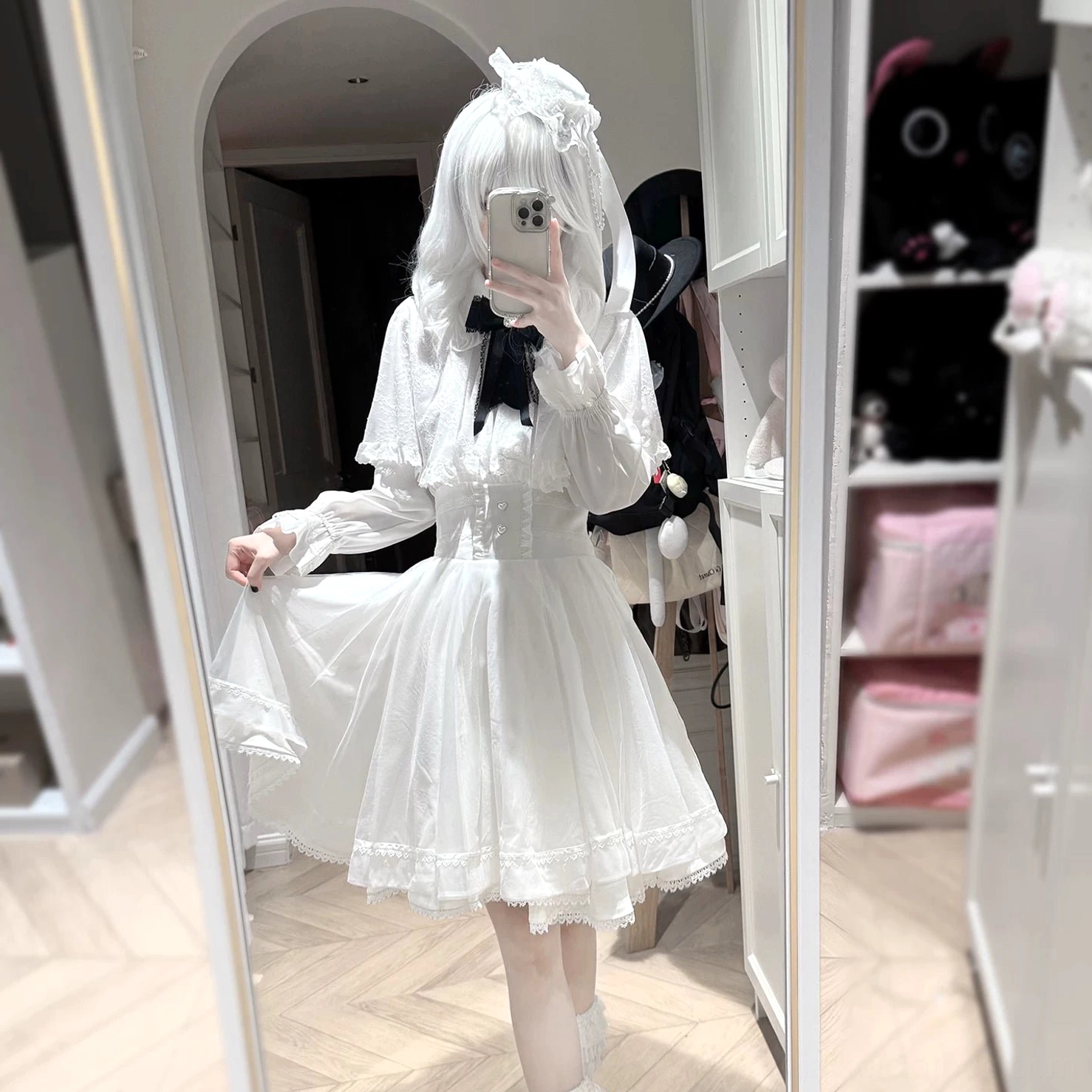 Gothic Jirai Kei outfit with sheer black capelet, satin bishop sleeves, corset-style waistband, twin-tailed styling with hair bows