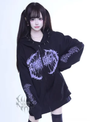 Black and purple Jirai Kei gothic zip hoodie with spiked hood trim, front three-quarter view on female model, oversized fit with purple prints and dual zippers