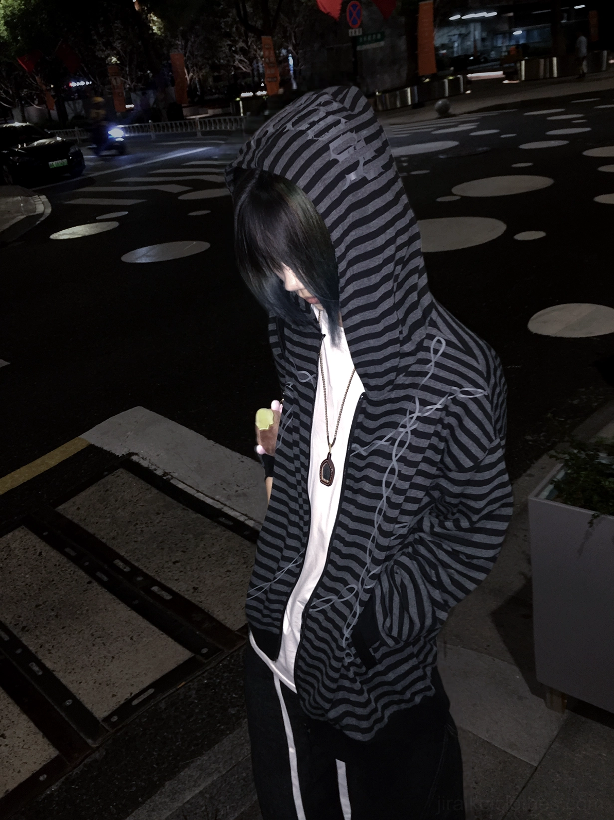 Gothic striped zip-up hoodie night street full-body view male model hood up hands in pockets, displaying stripe and chain print layered styling