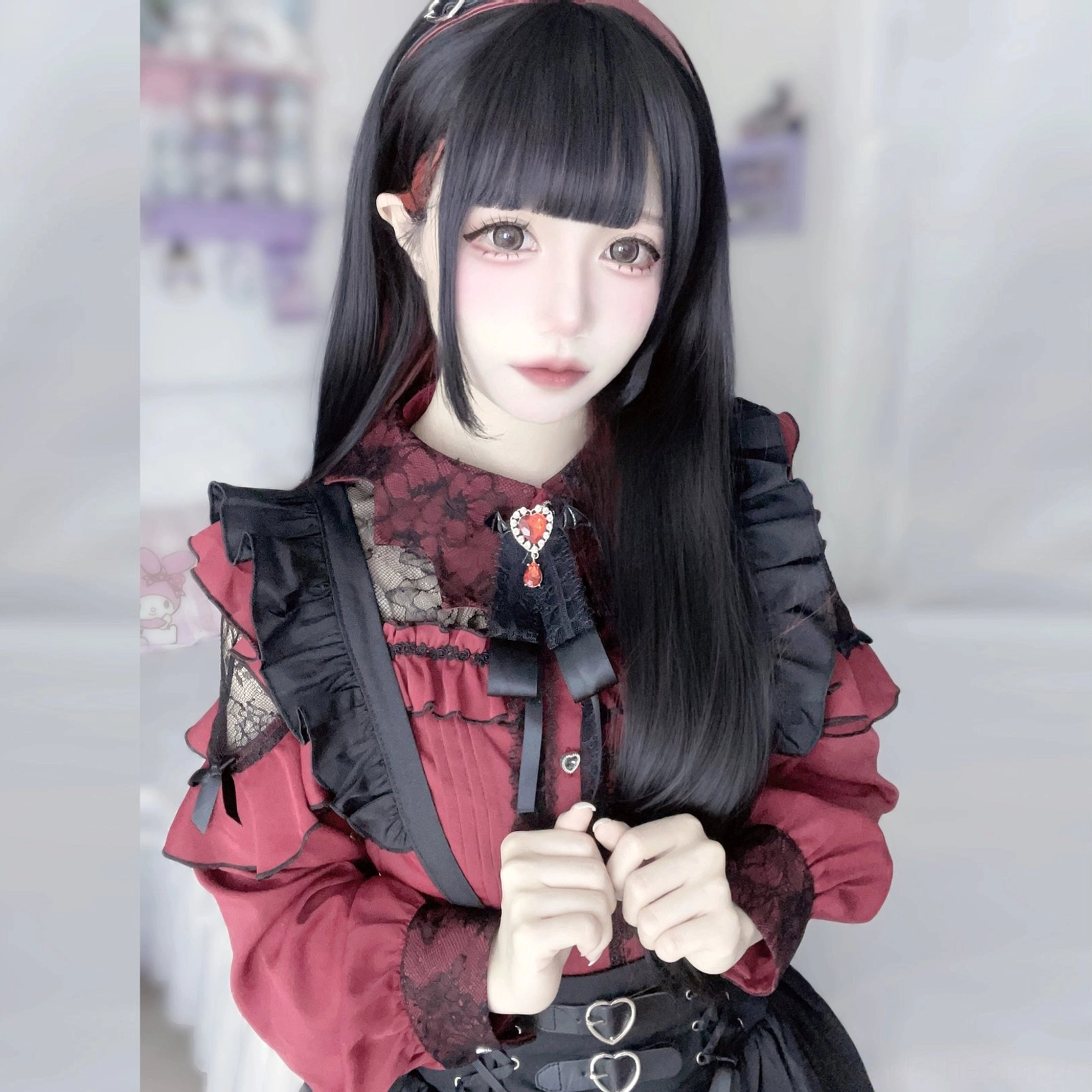 Alternative fashion styling Jirai Kei gothic lace blouse coordinate with cross prop and asymmetrical ruffled skirt
