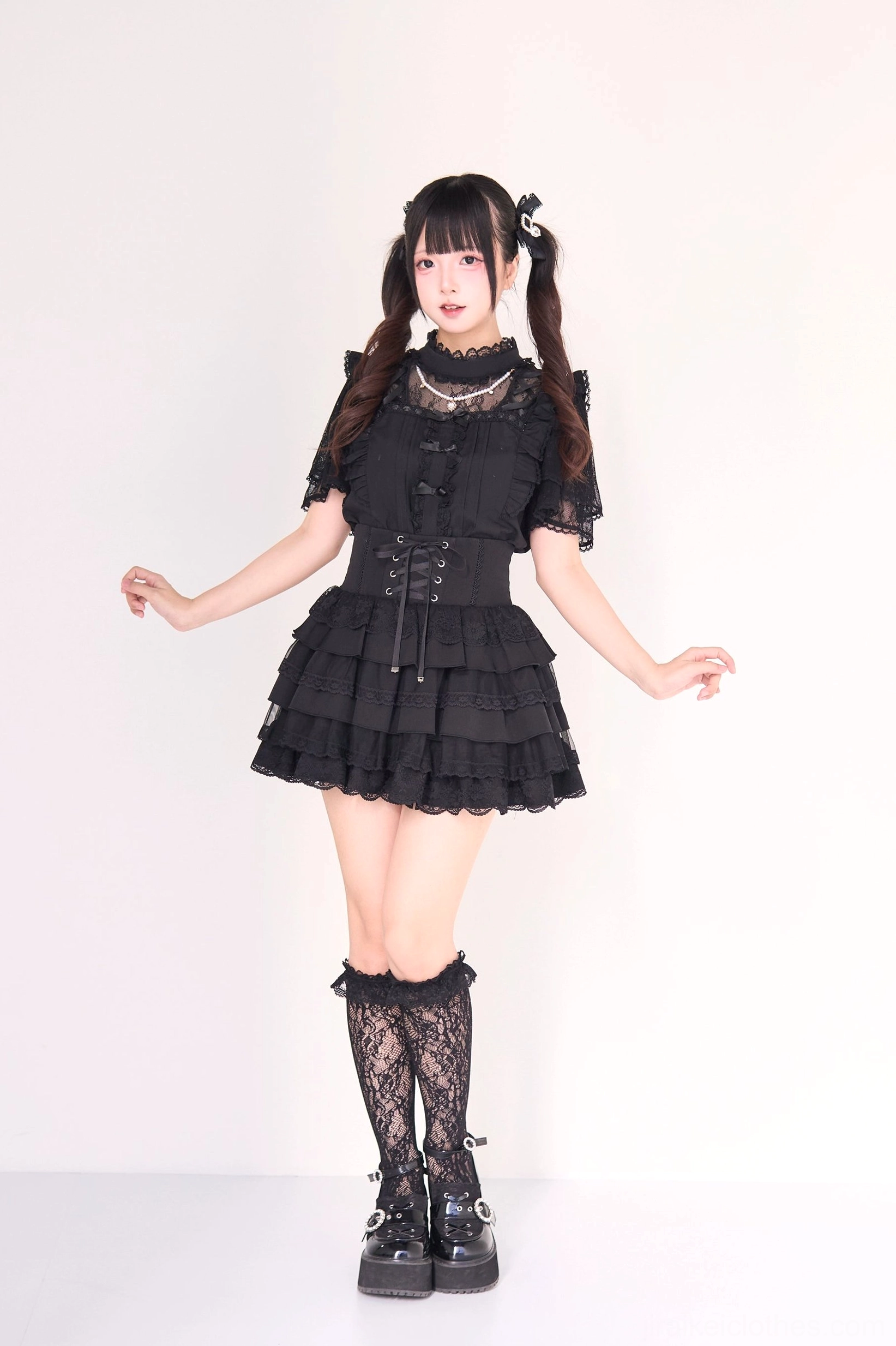 Jirai kei gothic lolita ensemble flat lay showing complete blouse and tiered cake skirt pieces with detachable pearl necklace accessory