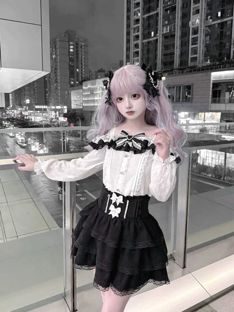 Gothic Lolita Jirai Kei off-shoulder blouse and layered lace skirt set modeled outdoors at night with light purple twin tails front view