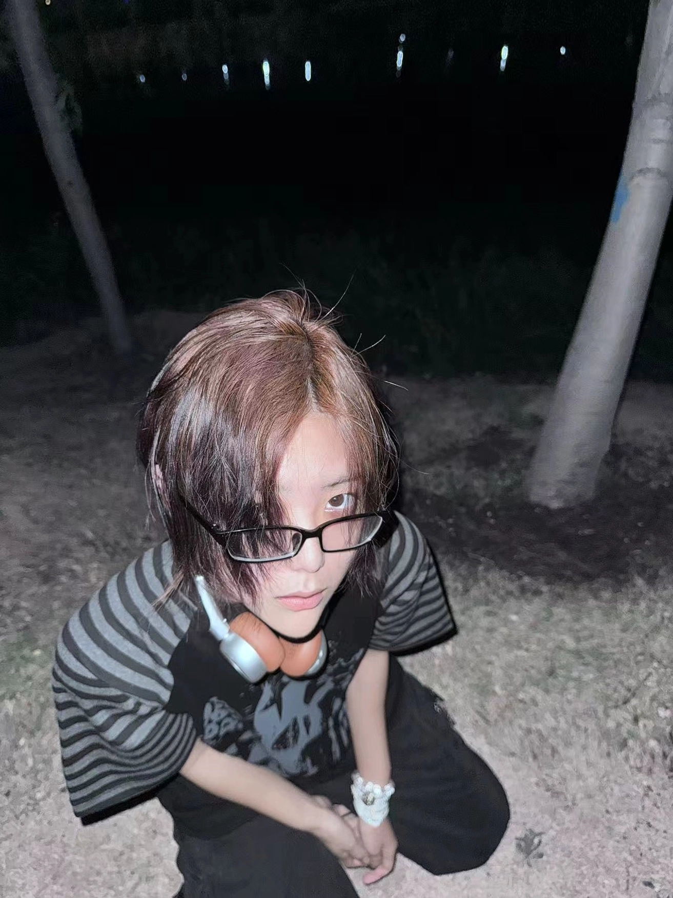 Low angle close-up jirai kei gothic skull raglan t-shirt black bodice grey striped sleeves glasses headphones