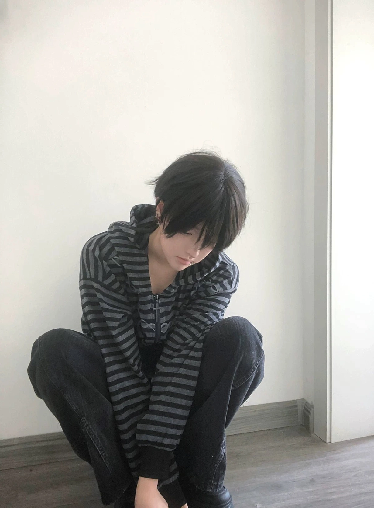 Gothic striped zip-up hoodie product lifestyle shot in underground aesthetic environment emphasizing Jirai Kei subculture authenticity