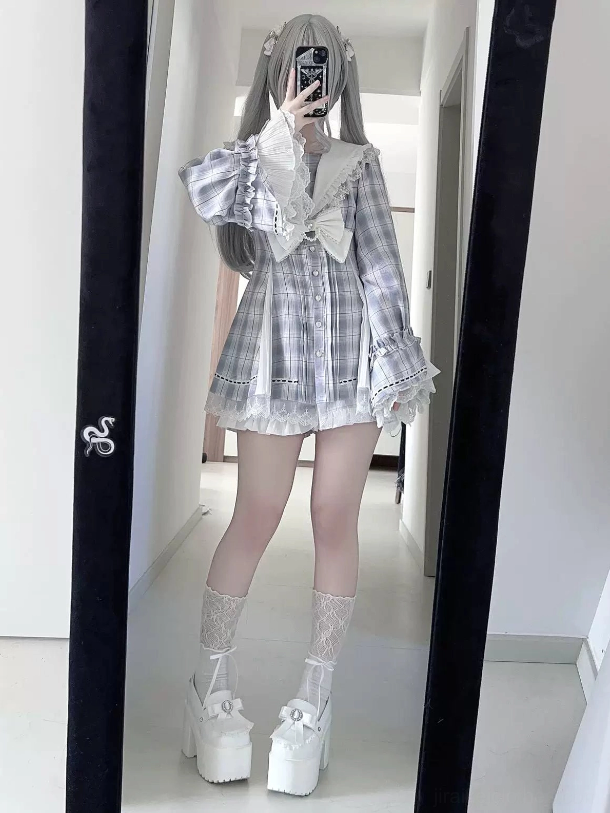 Gray plaid Jirai Kei sailor collar hime dress on silver-haired cosplayer in mirror selfie front view, featuring large front bow, lace socks, and chunky platform boots styling