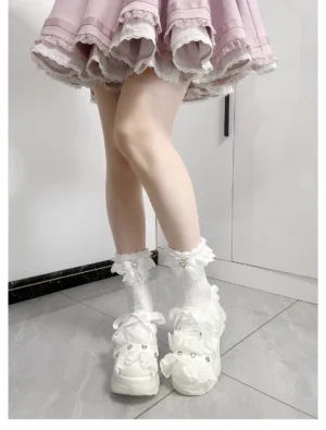 Jirai Kei heart knit mid-calf socks with white ruffled bow cuffs worn with pink Lolita skirt and white platform shoes