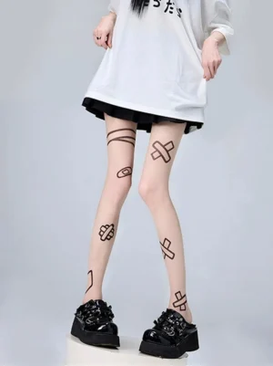 Jirai Kei injury tattoo print sheer pantyhose front view model wearing y2k casual outfit with nude base and black band-aid cross tattoo designs
