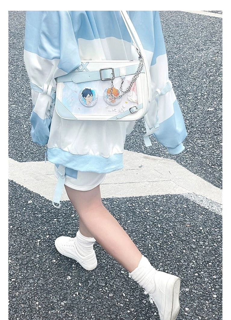 Jirai Kei ita bag detail shot showing crystal clear acrylic display window with vibrant anime character badges and patches