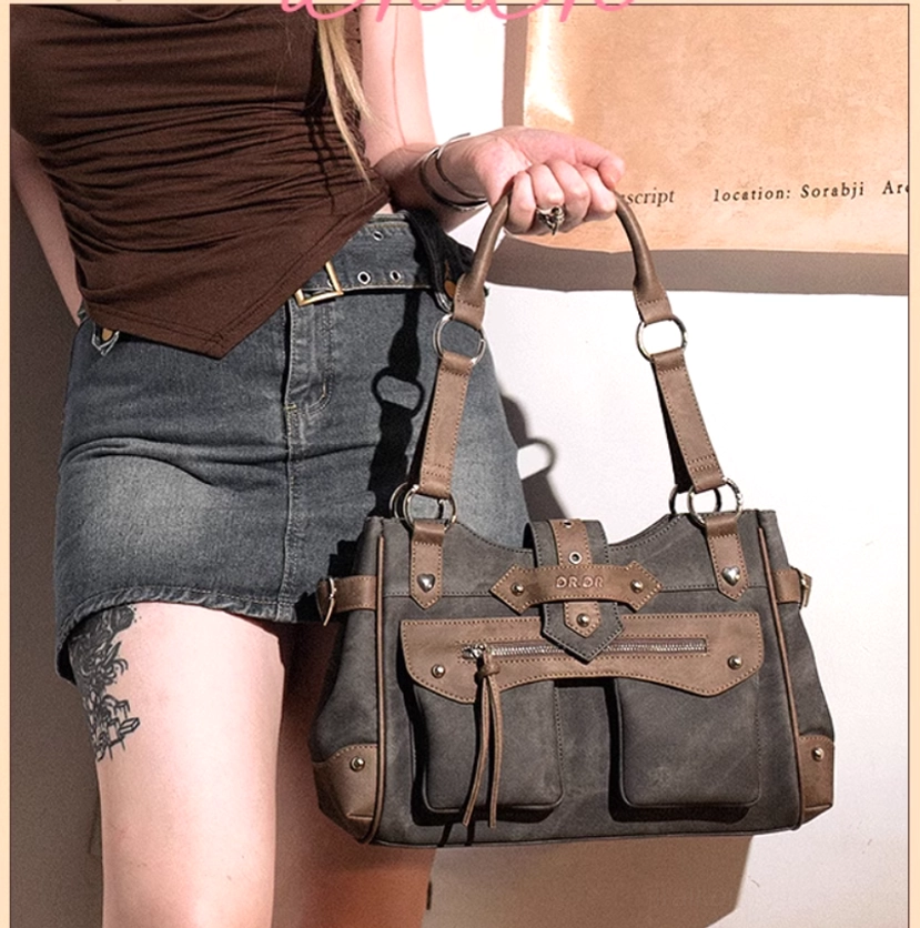 Model side-carrying denim blue Jirai Kei ita shoulder bag in casual indoor setting, showcasing matching grey-brown leather material and adjustable crossbody strap in daily wear context