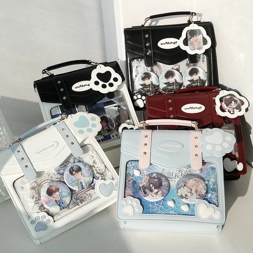 four assorted jirai kei ita bags top down flat lay black wine red light blue off-white colors clear display windows cat paw hardware