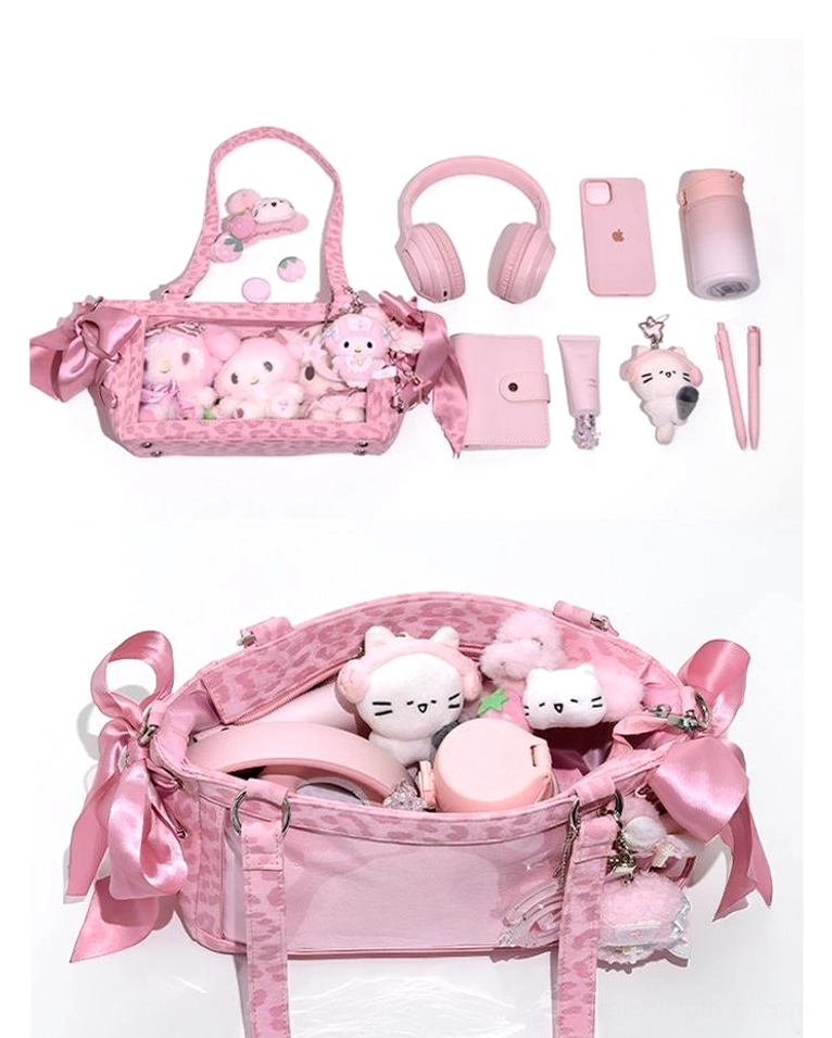 Pink Jirai Kei ita bag angled flat lay view displaying clear window with accessories and side satin bow decoration details