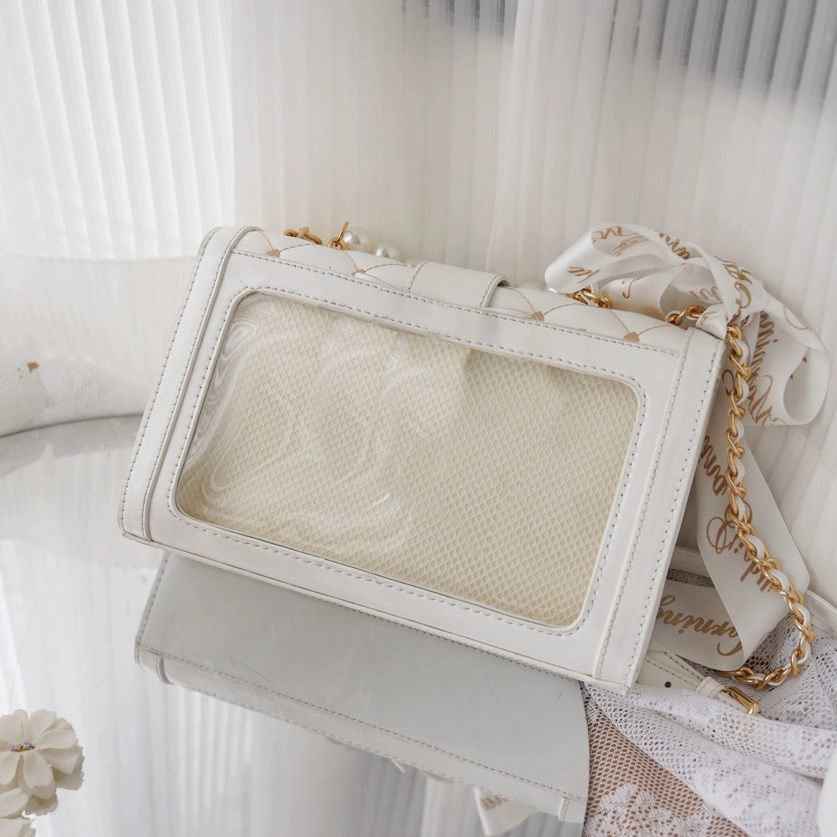 Patent leather white jirai kei ita shoulder bag with glossy finish and decorative bow on transparent display area