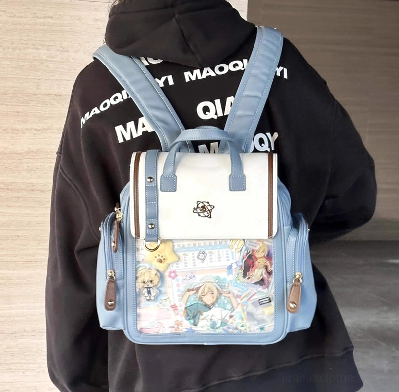 Wearing effect of blue and white Jirai Kei itabag backpack on model's back showing on-body styling with black hoodie