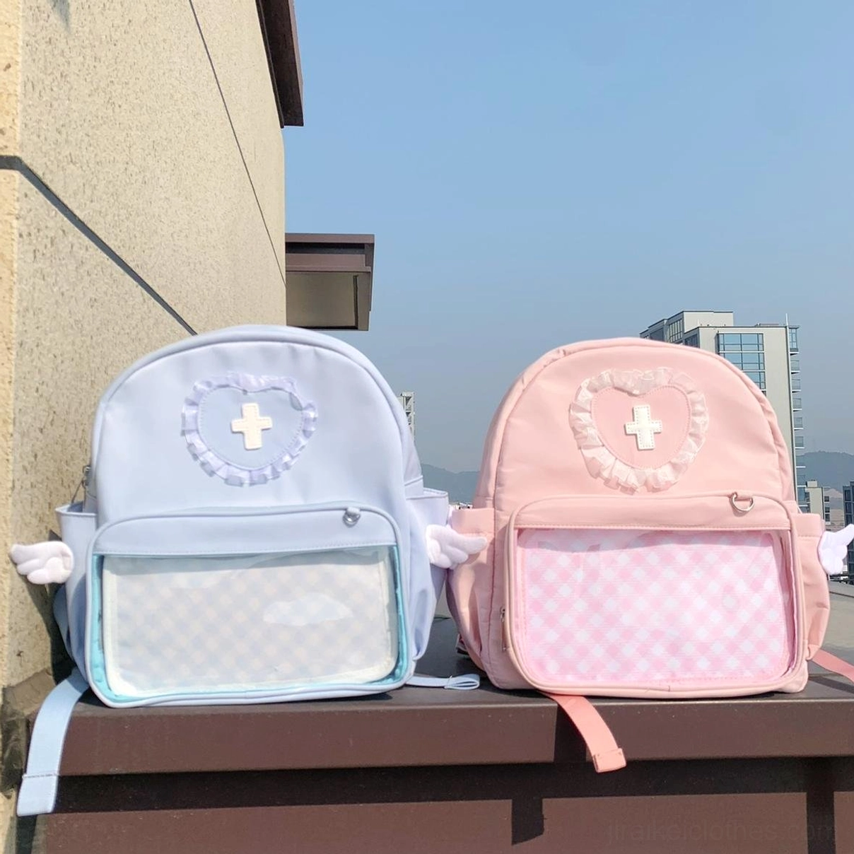 Jirai Kei itabag backpack detail shot showcasing intricate angel wing embellishments, heart-shaped lace cross decoration and premium nylon fabric construction
