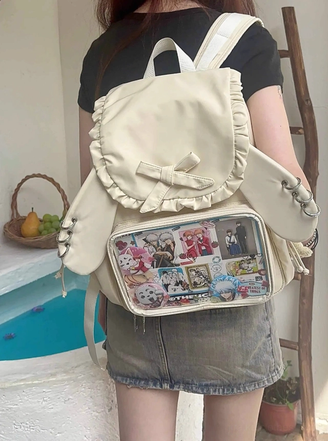 Close-up detail of Jirai Kei itabag backpack ruffled butterfly bow accent and premium water-resistant nylon fabric texture