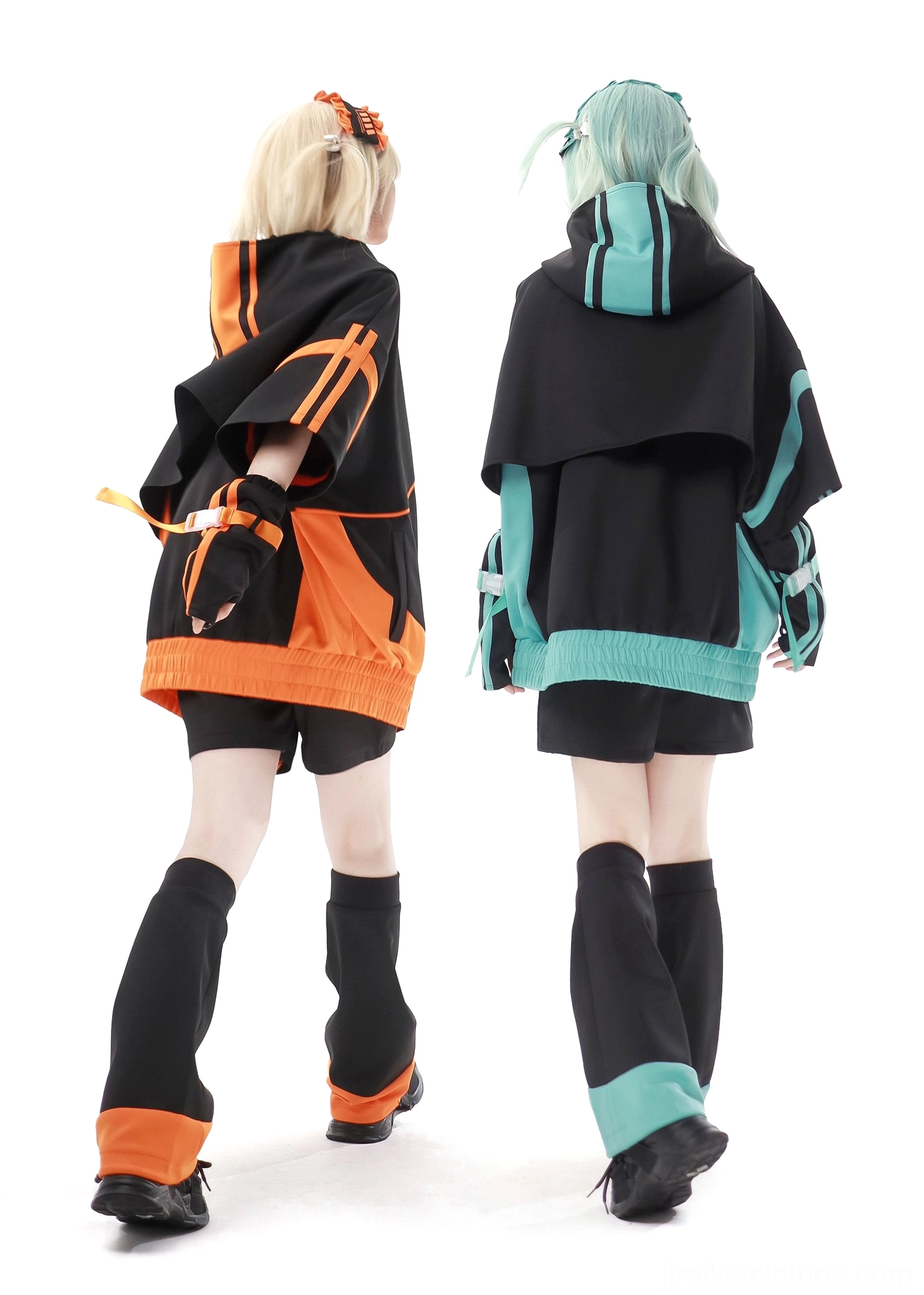 Back view of two models wearing Jirai Kei jacket outfits showing hooded design contrast trims and leg warmers coordination black background studio