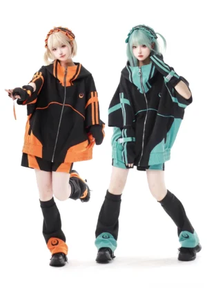 Two female models wearing oversized black-teal and black-orange Jirai Kei jacket sets with matching leg warmers and embroidered headbands, front full-body group shot studio photography