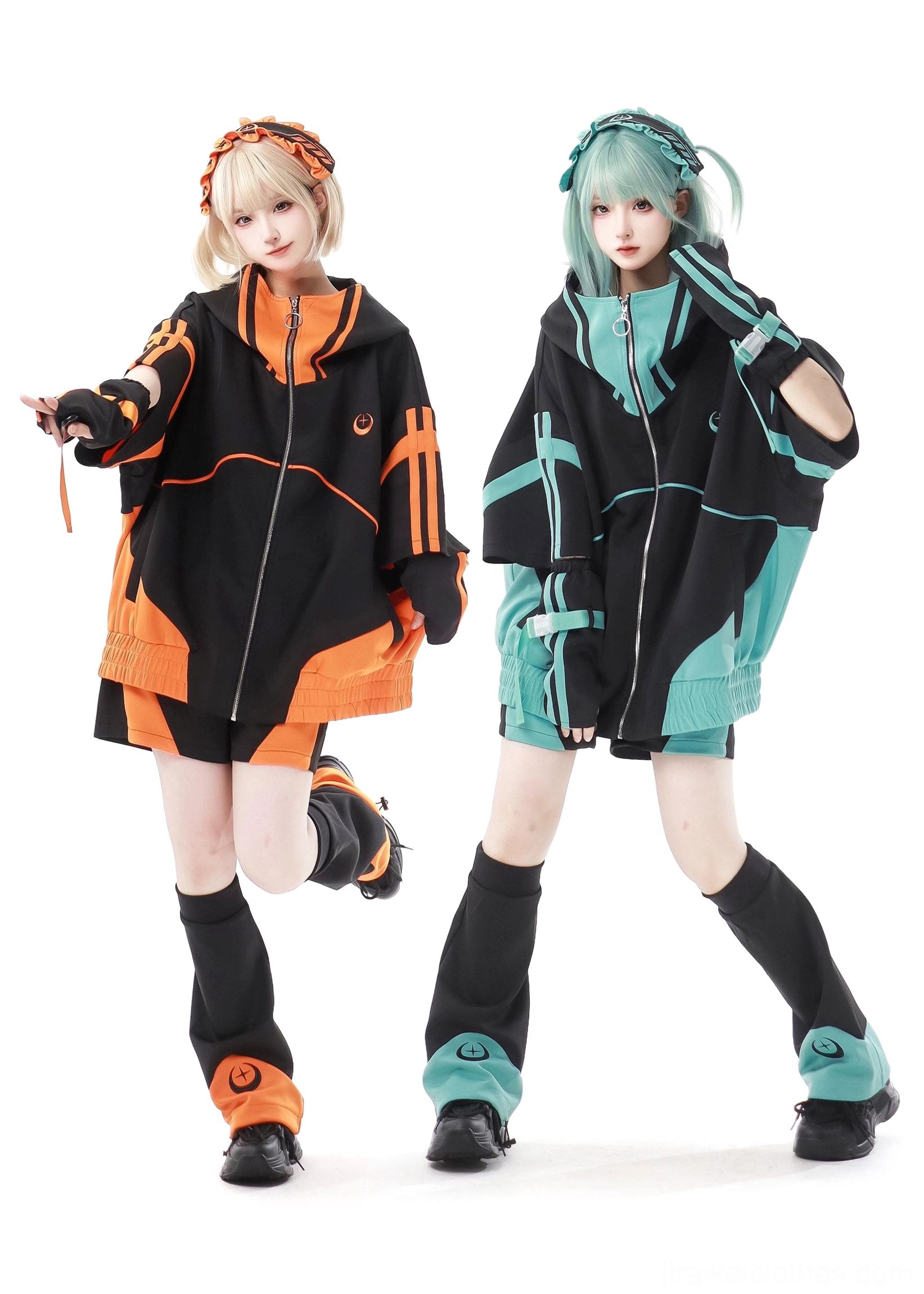 Two female models wearing oversized black-teal and black-orange Jirai Kei jacket sets with matching leg warmers and embroidered headbands, front full-body group shot studio photography
