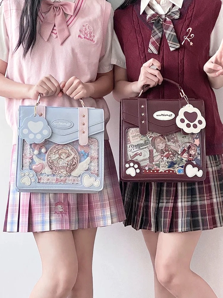 handheld jirai kei jk ita bags two girls school uniforms detailed anime prints clear display windows cat paw pendants front view