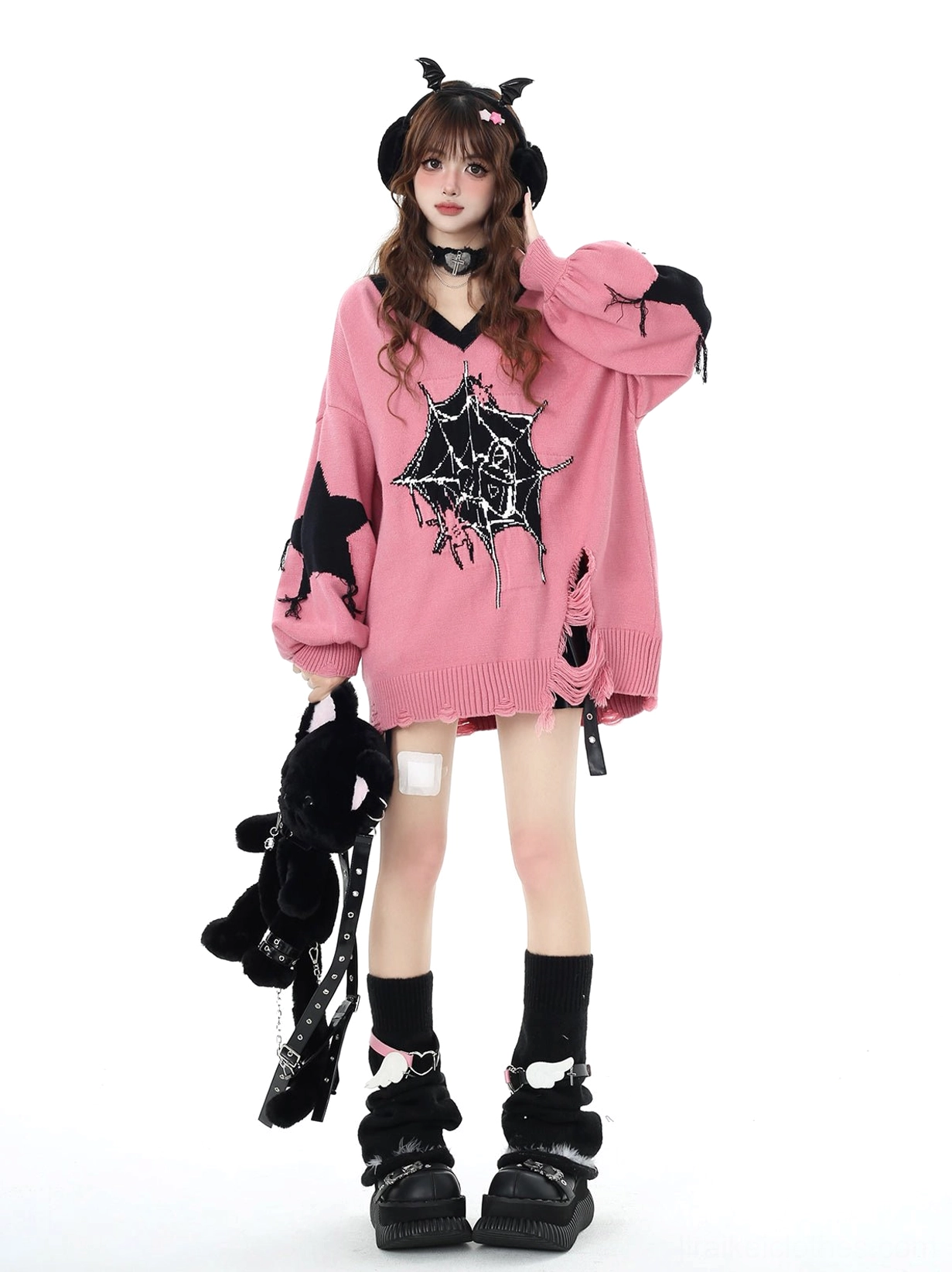 Black and pink Jirai Kei knit sweater detail shot showing core-spun yarn texture and spider web print craftsmanship