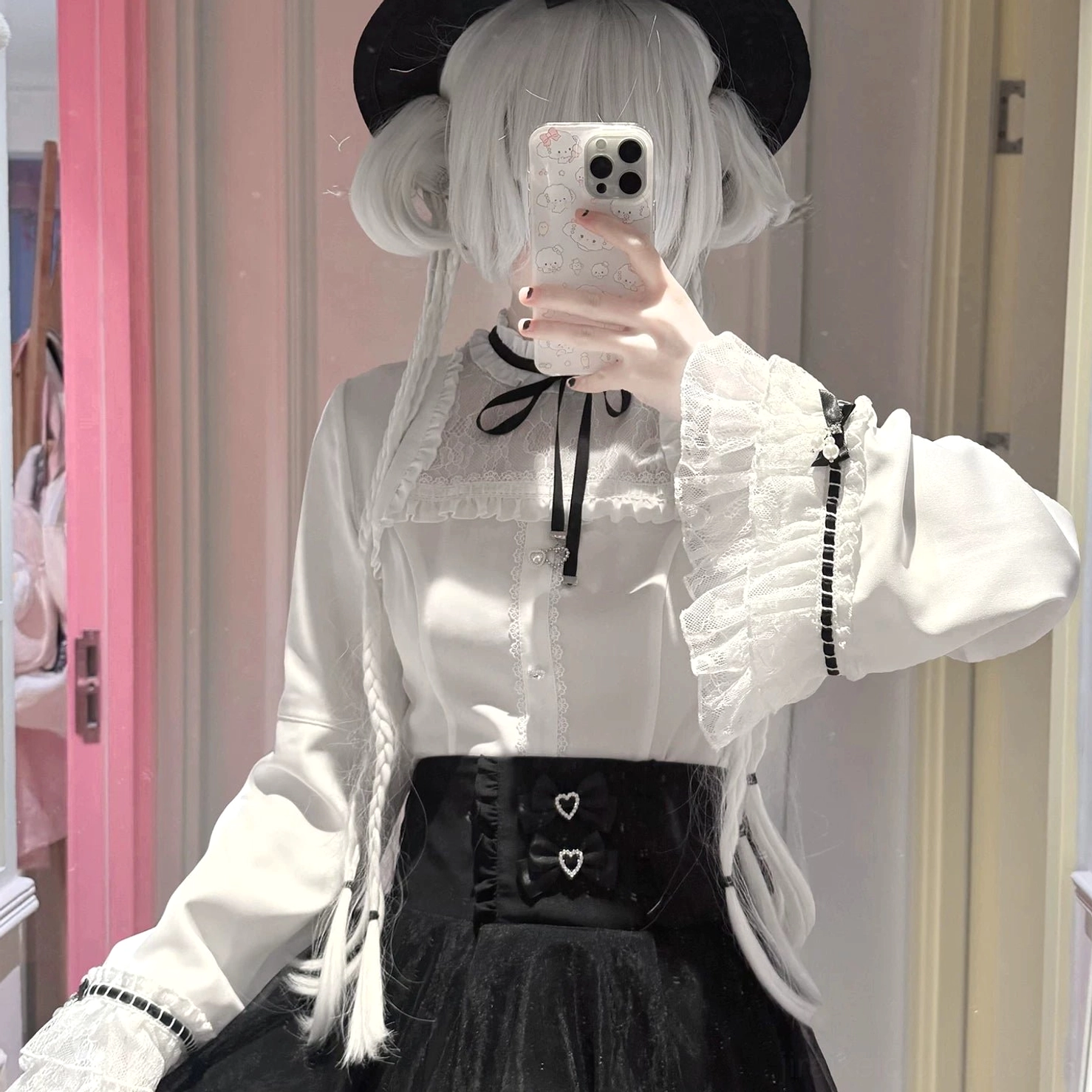 Half-body selfie showcasing jirai kei ruffled lace blouse with flared sleeves, black ribbon bow at neck, and structured collar detail