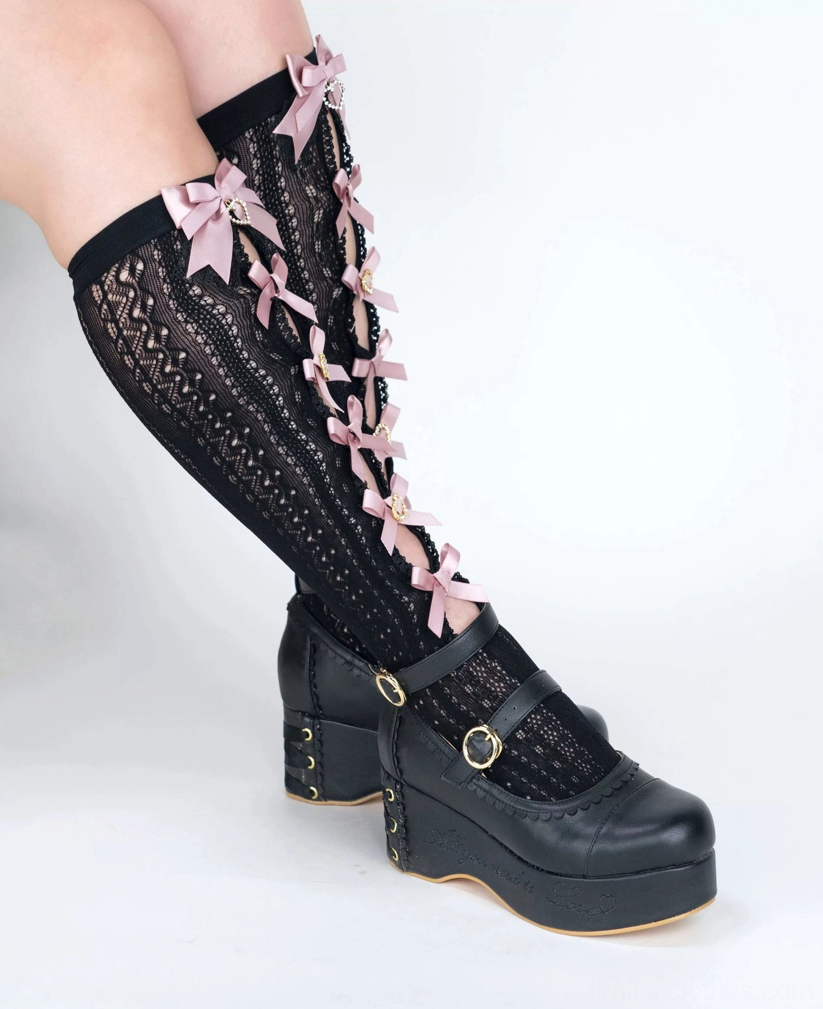 Black Jirai Kei lace bow mid-calf socks side view single leg pink ribbon bows hollow lace fabric texture platform shoes