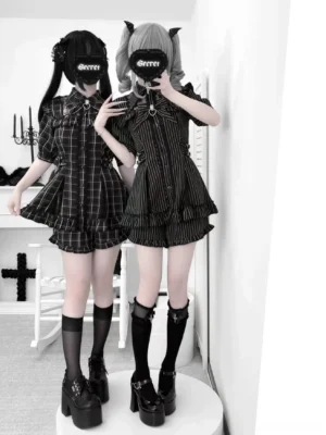 Jirai Kei lolita two-piece dress set full front body view on masked female models wearing dark ruffled hems and platform shoes in gothic styled interior room