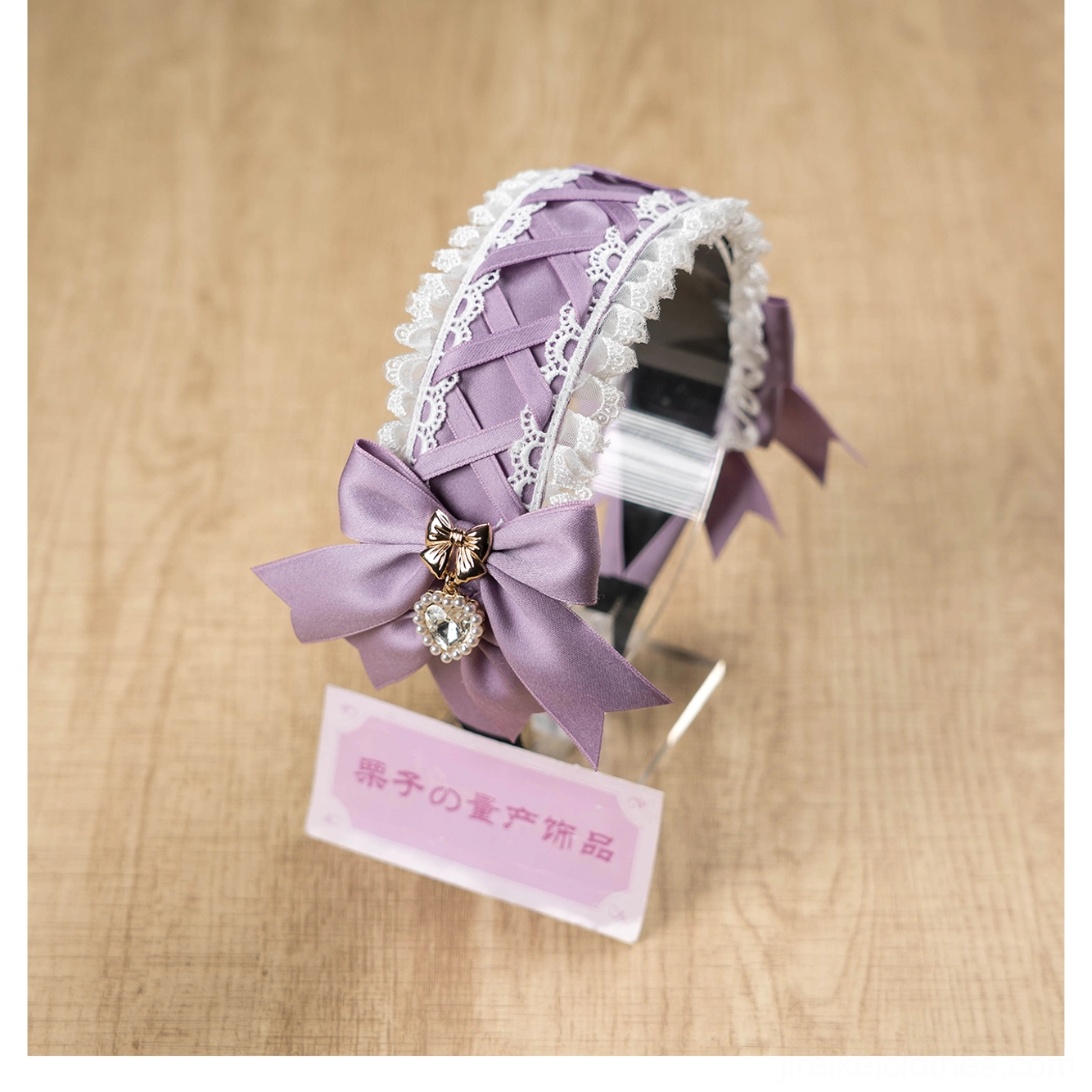 Close-up detail of Jirai Kei lace headband rhinestone heart pendant and satin bow showing quality craftsmanship, light reflection on crystals, and delicate ruffled lace construction