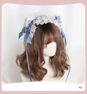 Mist blue Jirai Kei lace headdress with detachable fluffy cat ears, white ruffle lace, light blue satin bows, long white ribbons, worn on mannequin with brown curly wig, front three-quarter view