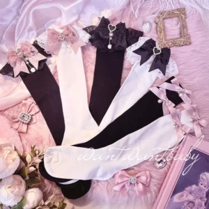 Assorted Jirai Kei over-the-knee lace socks flat lay featuring black and white color options with decorative bows and pearl trim accents on vintage pink plush backdrop