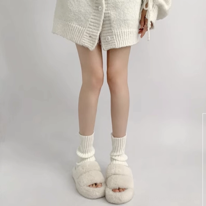 Cream white simple ribbed knit jirai kei leg warmer 30cm ankle-calf length styled with fuzzy slides and knitted cardigan indoor background