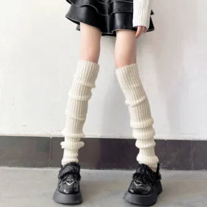 Cream white over-the-knee jirai kei stacked ribbed leg warmer 70cm length paired with black leather mini skirt and platform loafers front full leg view
