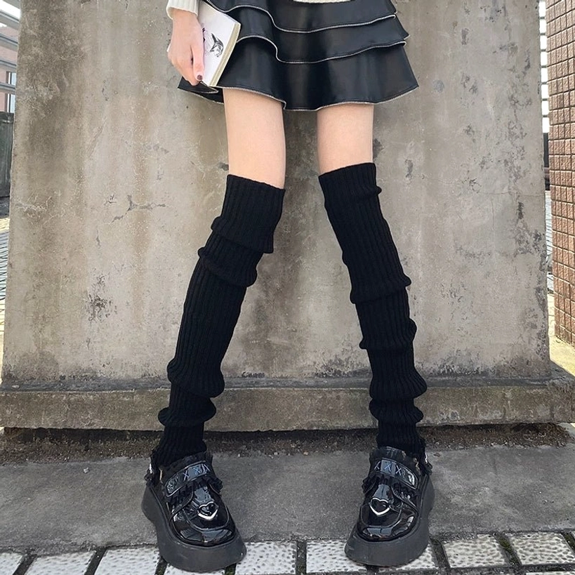 Pure black over-the-knee tight ribbed knit leg warmer jirai kei style with leather mini skirt and platform shoes outdoor concrete wall