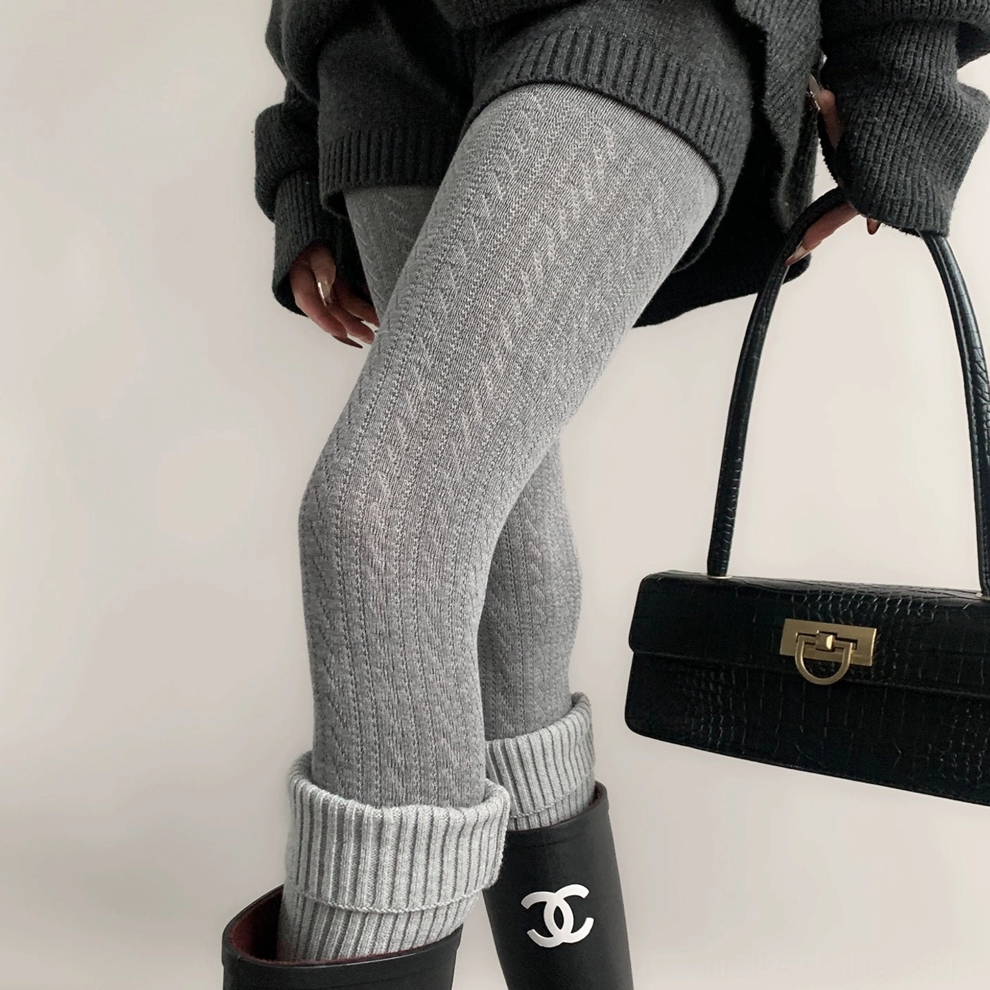 Light gray Jirai Kei hollow tights rear side view with dark knit top leather handbag and rain boots styling
