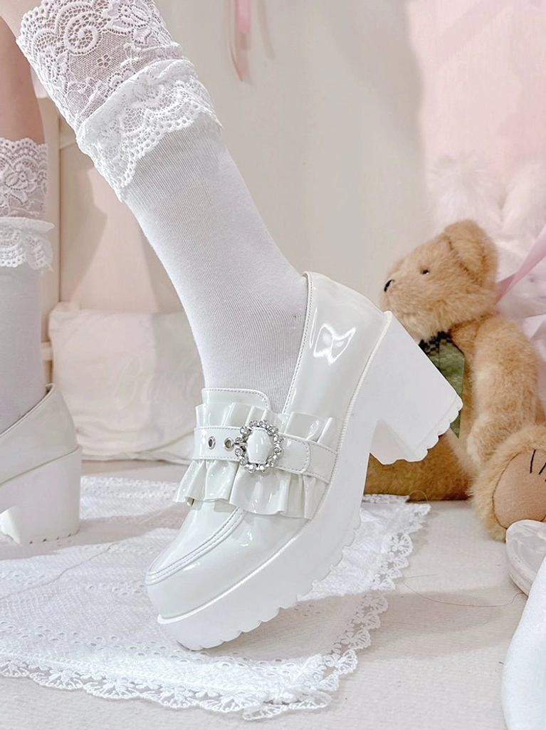 Jirai Kei mid-heel loafers three-quarter view displaying complete shoe silhouette with platform heel height, bow clip placement, buckle strap design and overall aesthetic presence