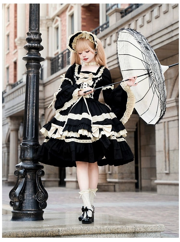 Classic black and beige Jirai Kei Lolita one-piece dress side view flared long sleeves layered ruffled skirt beige trim parasol