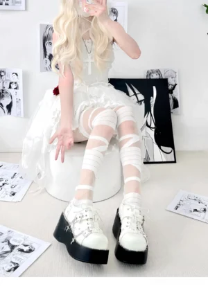 white transparent bandage stockings lolita style sitting view eye-level wrapped strap pattern paired with white platform shoes gothic lolita aesthetic