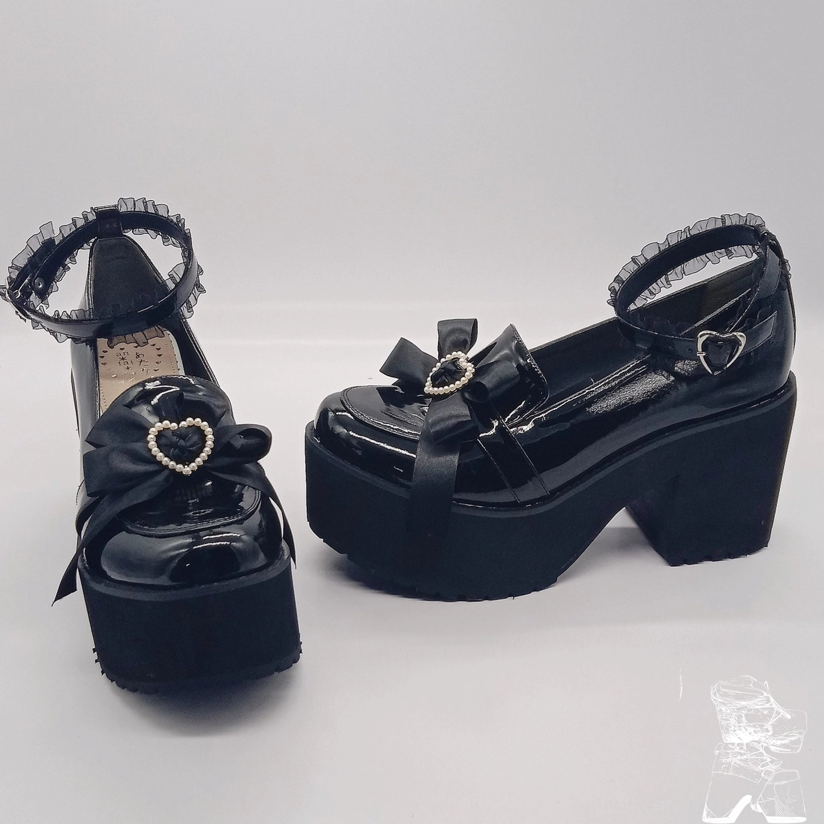 Black patent Lolita platform shoes side angled view showing thick block heel heart buckle bow decoration glossy finish