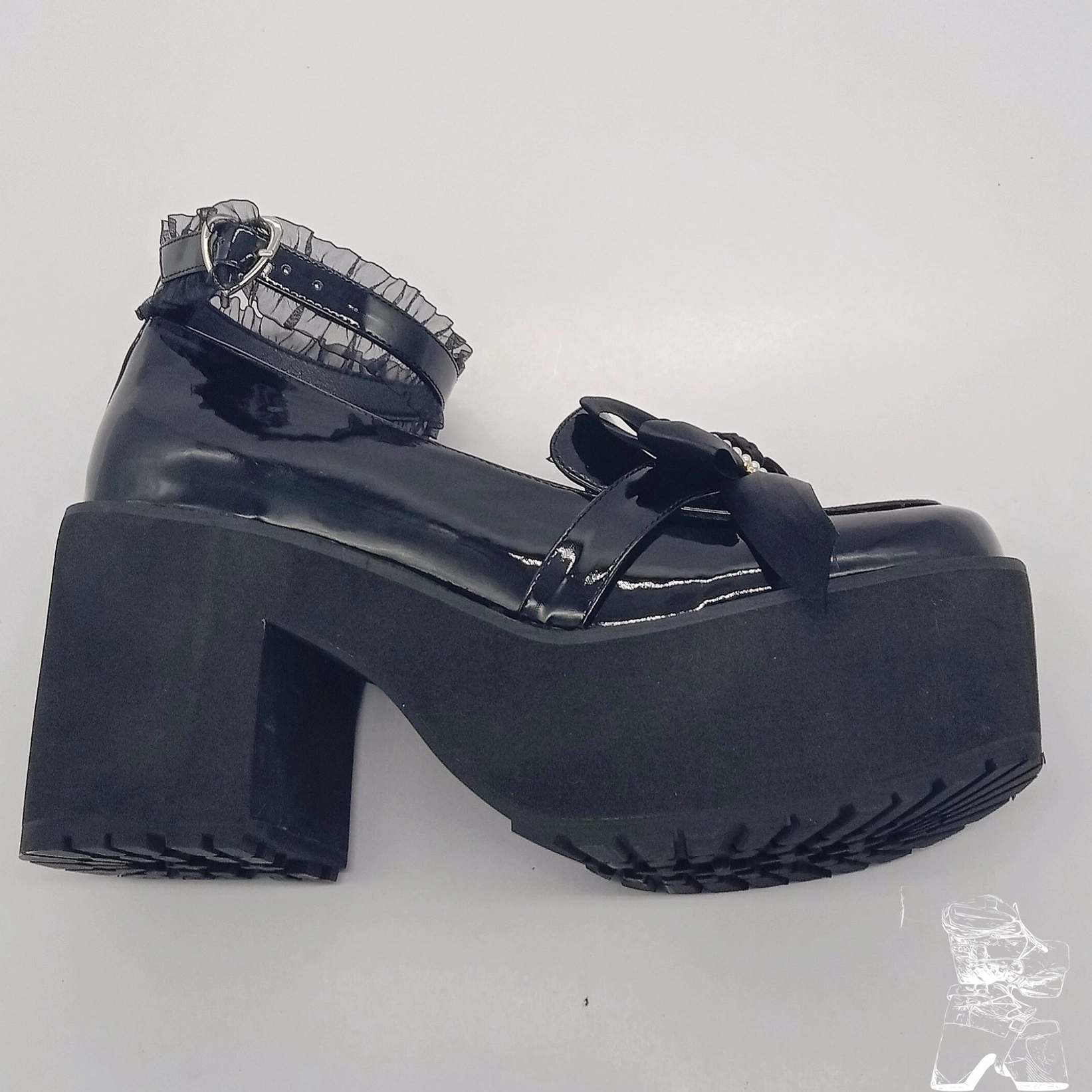 Side profile single black patent leather Lolita platform shoe textured rubber outsole block heel lace ankle strap bow