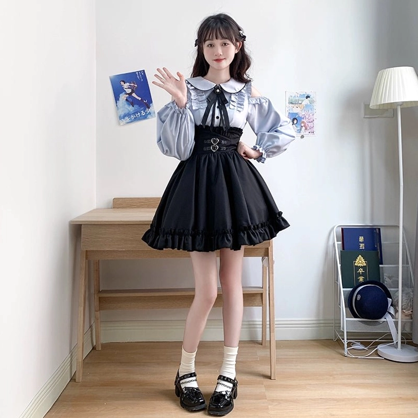 Styled full-body presentation of Jirai Kei two-piece outfit with long-sleeve blue cold-shoulder blouse, black ruffled skirt, coordinated accessories and authentic subculture styling