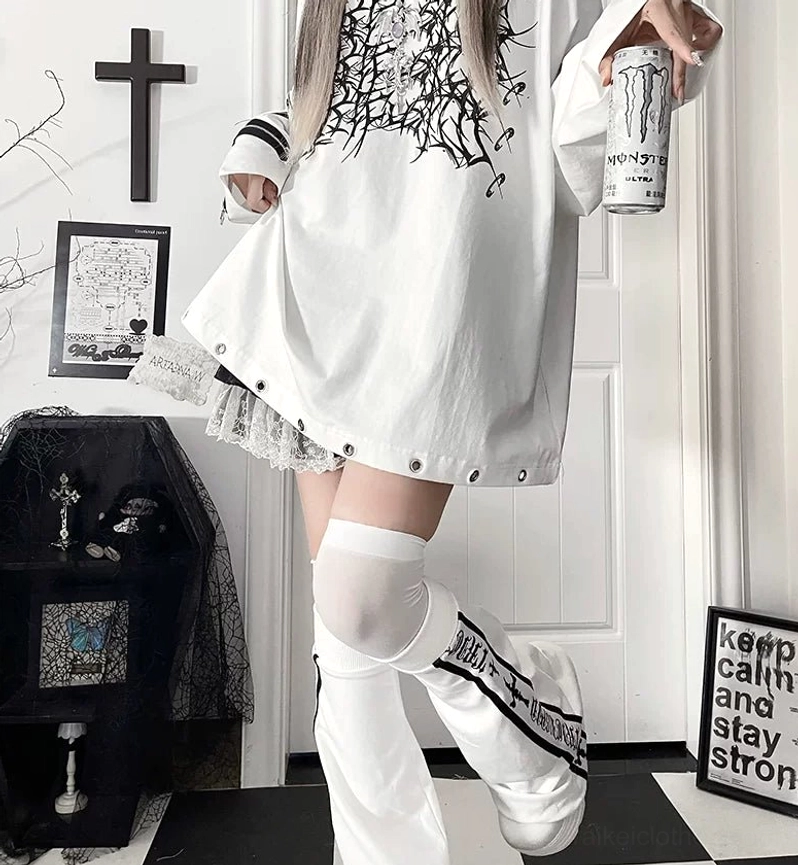 Flat lay product image of oversized jirai kei gothic long-sleeve t-shirt displaying full front print design, sleeve zipper details, and overall garment silhouette