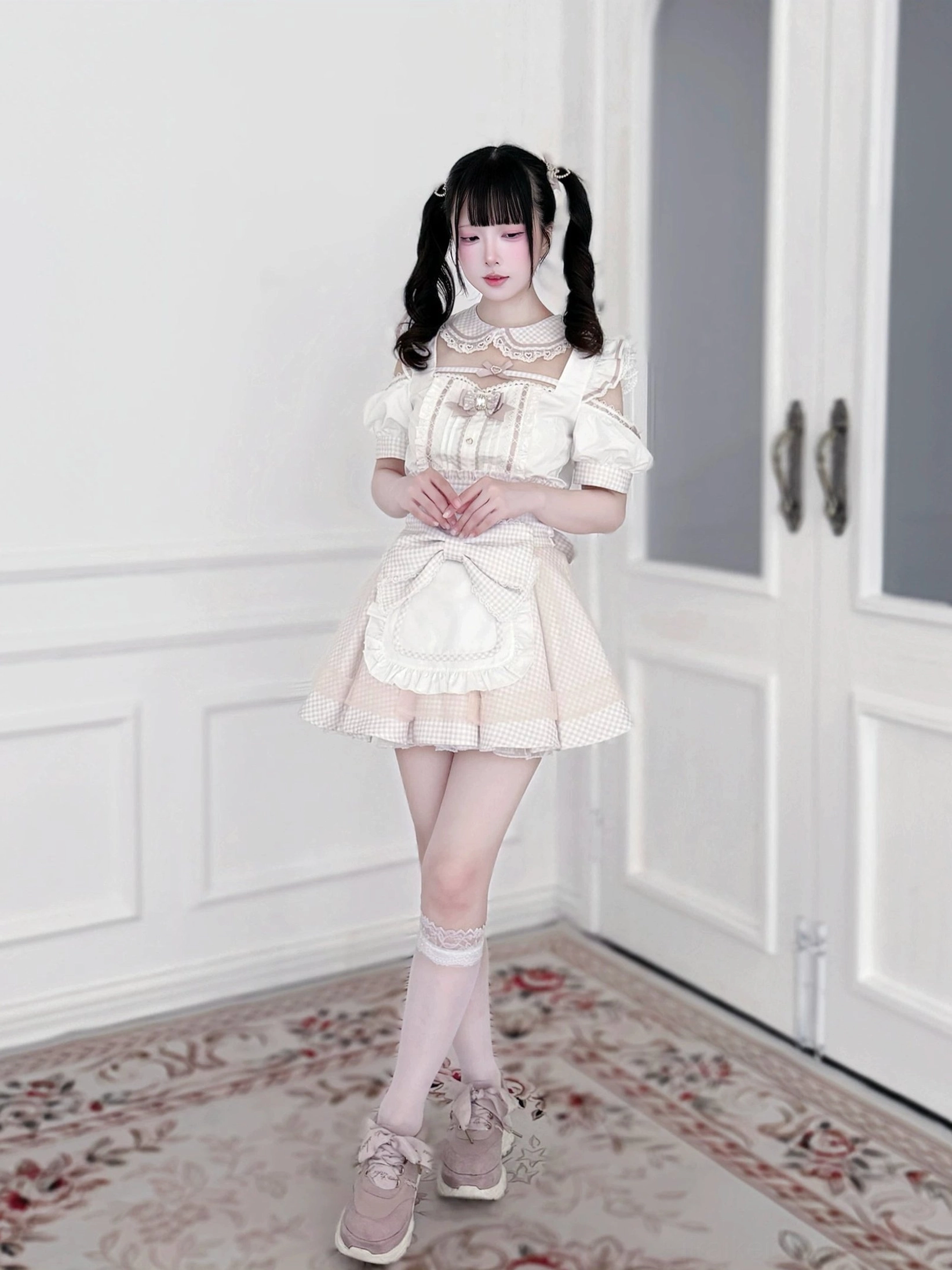 Detachable apron component detail of Jirai Kei maid outfit showing removable construction, ruffled design, and attachment mechanism