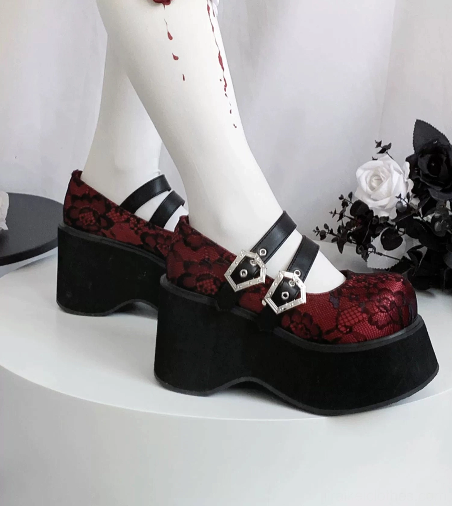 Mary Jane platform shoes with black lace upper displaying intricate lace pattern texture dual silver buckles and thick platform sole detail