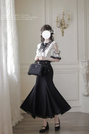 Gothic Lolita ankle-length mermaid skirt ensemble side back view showcasing flowing hemline ruffled off-shoulder blouse design and vintage indoor aesthetic